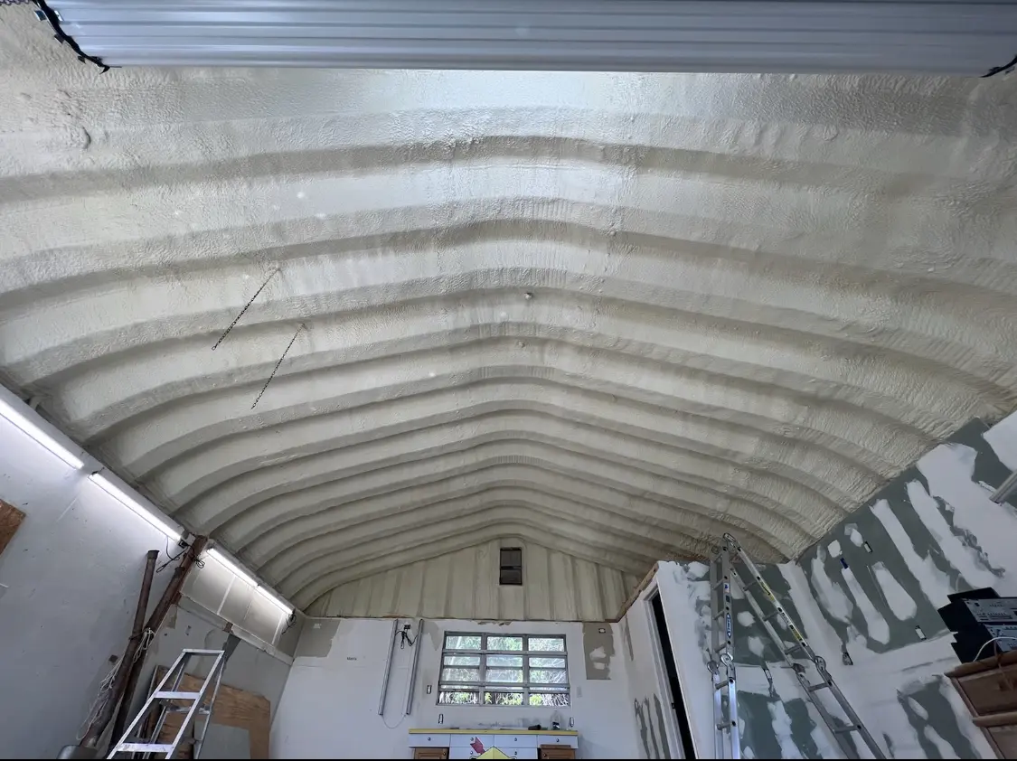 Spray polyurethane foam applied to the underside of a metal roof deck in Stamford